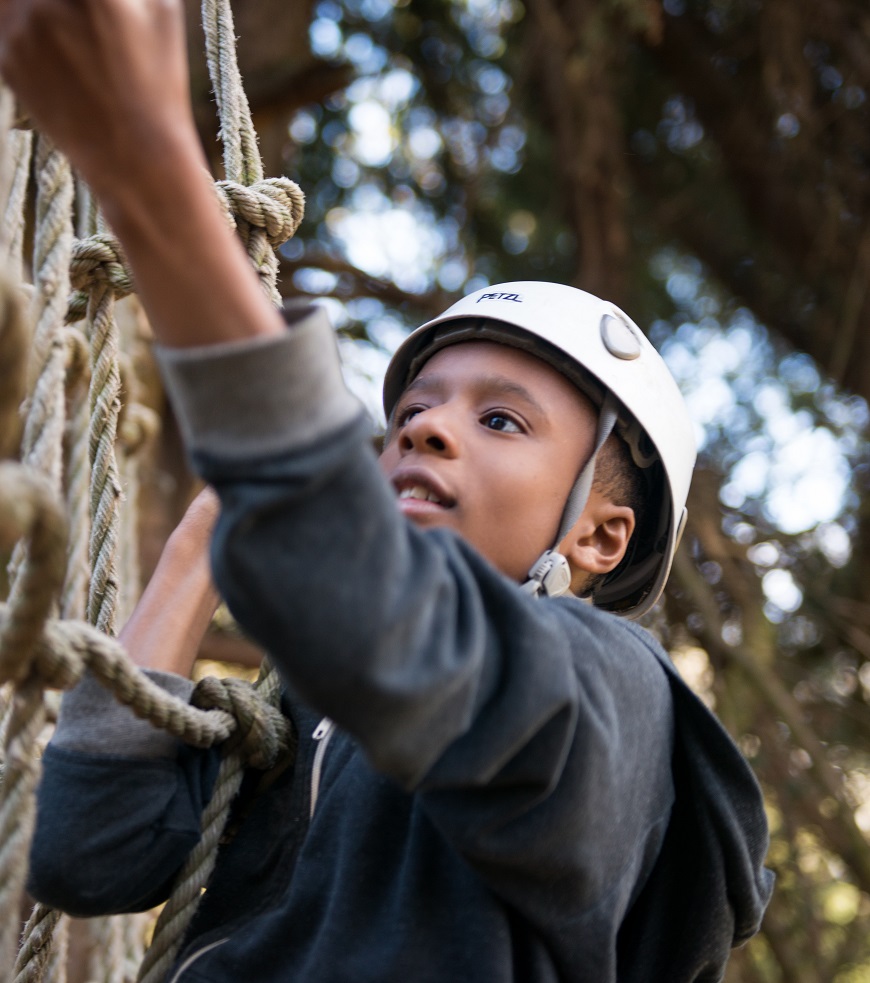 Young person climbing on adventure course