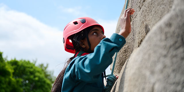 Young person climbing on adventure course