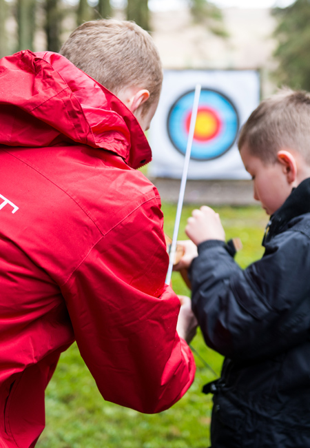 Archery Instructor teaching a young person