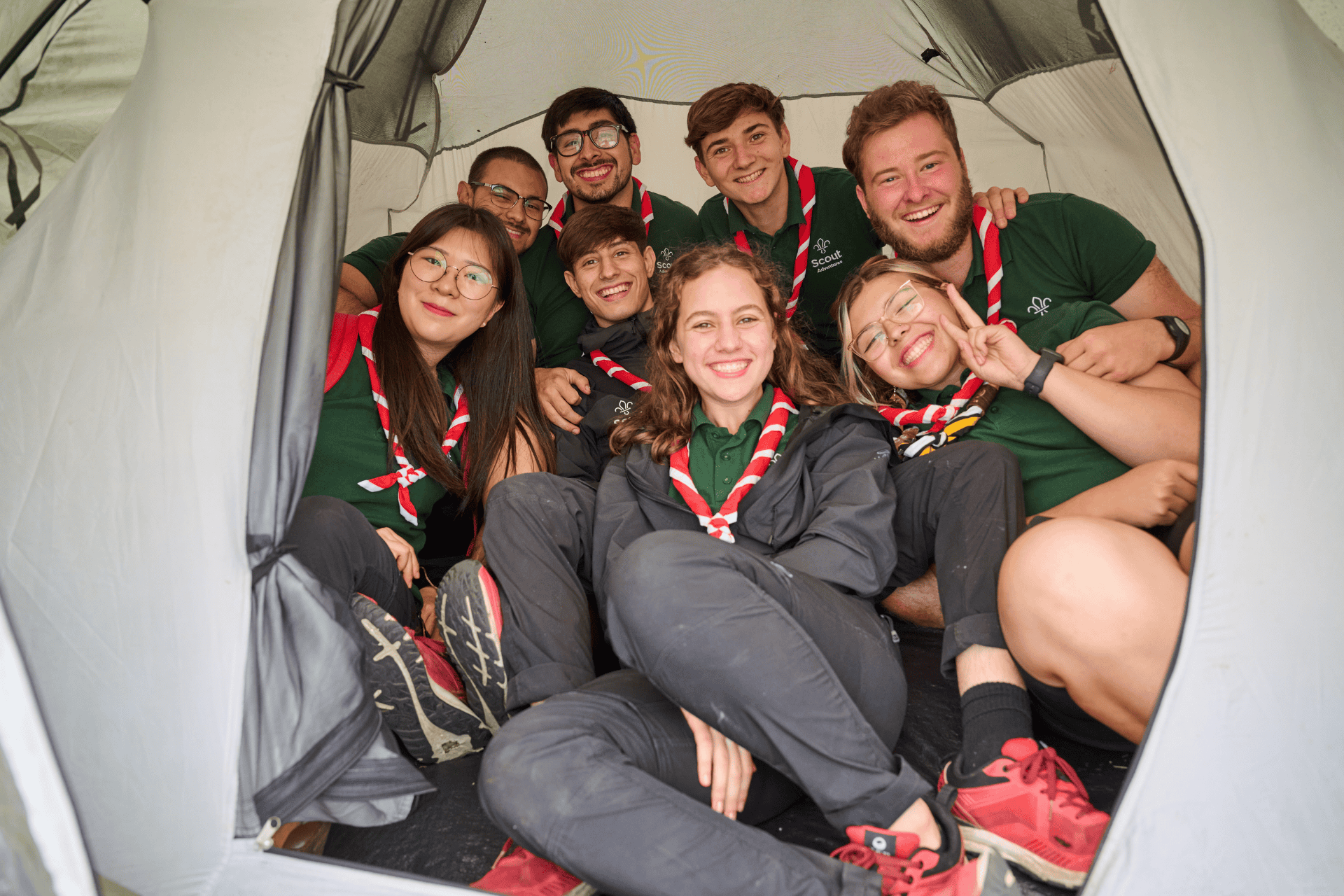 Group of volunteers in a tent smiling 