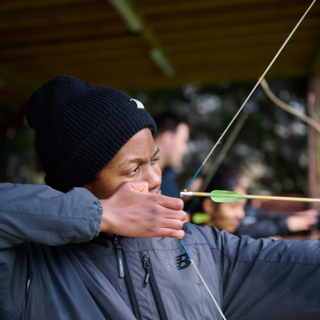 a young person doing archery