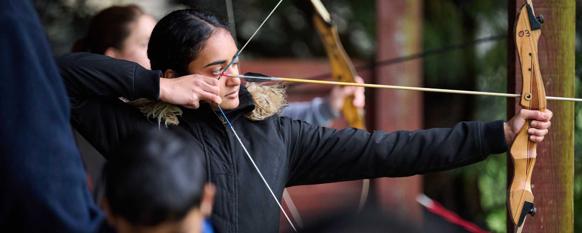 Young person taking part in an archery session